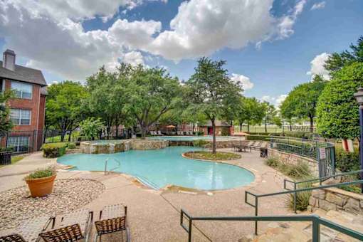 the preserve at ballantyne commons pool and spa with trees and a blue sky