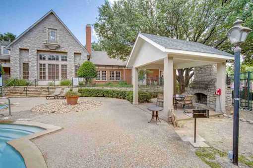 the backyard of a house with a pool and a pavilion