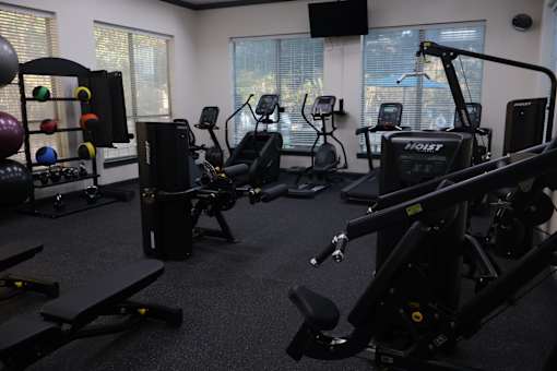 Fitness center with cardio and strength equipment at Clearwater Creek Apartments, Richardson, 75082