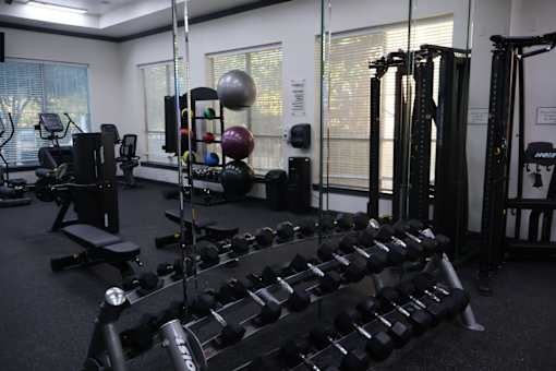 Fitness center with free weights and equipment at Clearwater Creek Apartments, Richardson