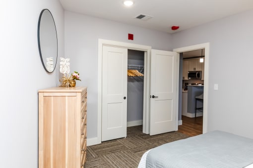 a bedroom with a bed and a dresser