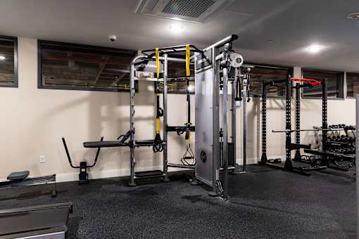 a gym with weights and cardio equipment in a home
