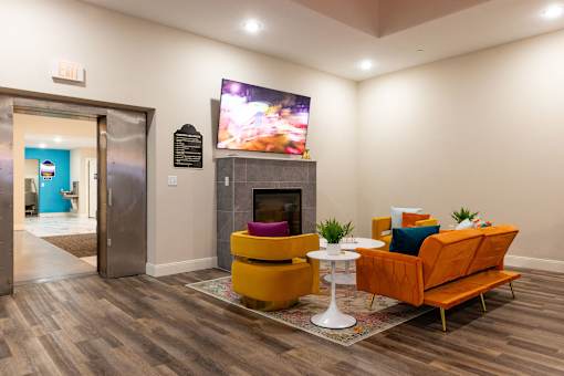 a living room with a fireplace and a tv