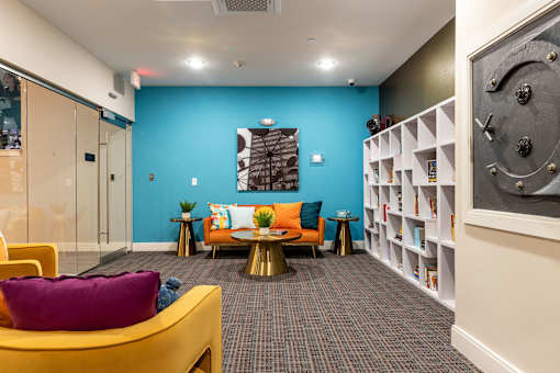 a living room with a blue wall and yellow furniture