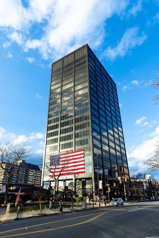 a large flag in front of a tall building