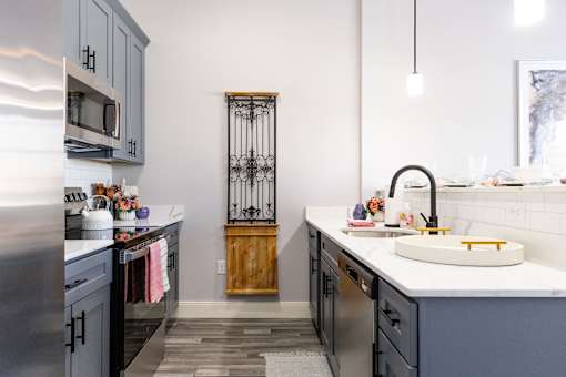 A modern kitchen with a sink and a refrigerator.