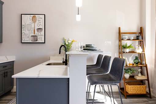 A kitchen with a white counter and a sink.