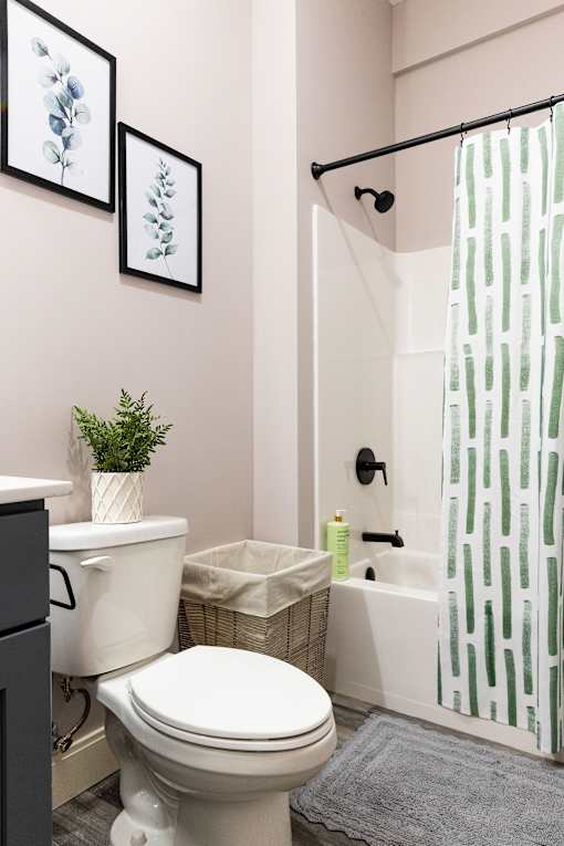 A white toilet sits next to a white sink in a bathroom.