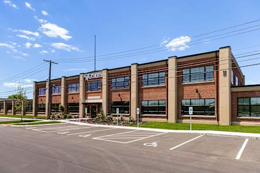 A large building with a parking lot in front of it.