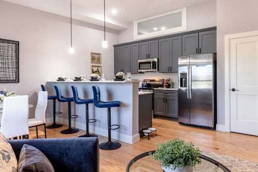 A kitchen with a bar area and a dining table.
