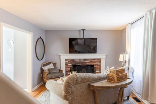 A living room with a fireplace and a chair.