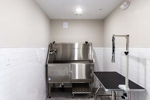 A stainless steel kitchen with a large pot on the stove.