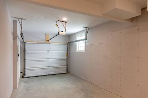 A garage with a white door and a window.