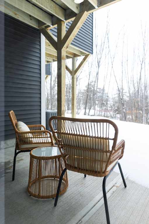 A patio with a chair and a table.