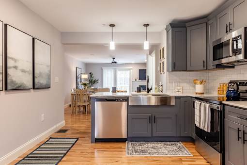 A modern kitchen with a large island and stainless steel appliances.