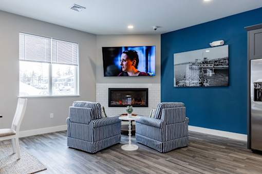 A living room with a fireplace and a television on the wall.