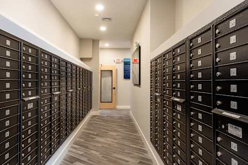 A long hallway with a row of mailboxes on either side.