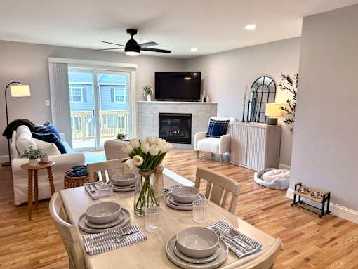 A dining room with a table set for a meal.