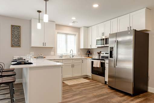 A modern kitchen with a large island and stainless steel appliances.