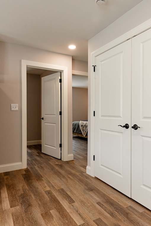 A white door is open to a hallway.