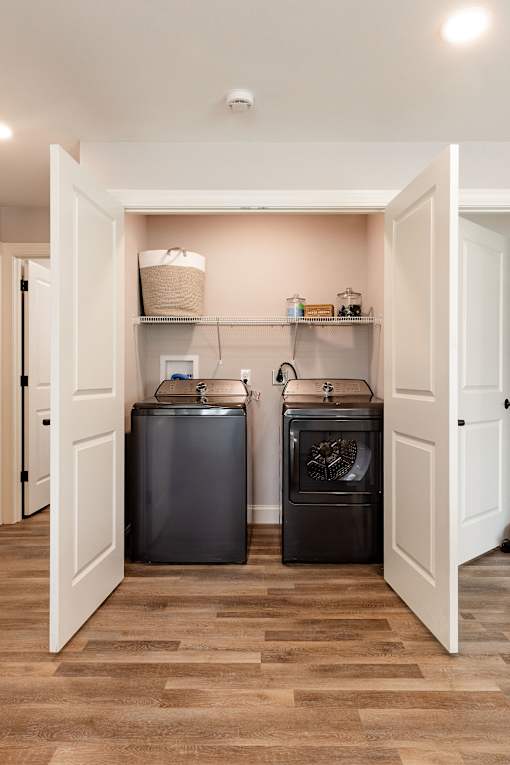 A kitchen with a black dishwasher and a black oven.