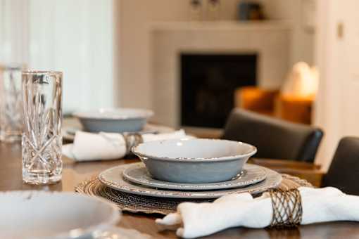A table set with plates, glasses and napkins.