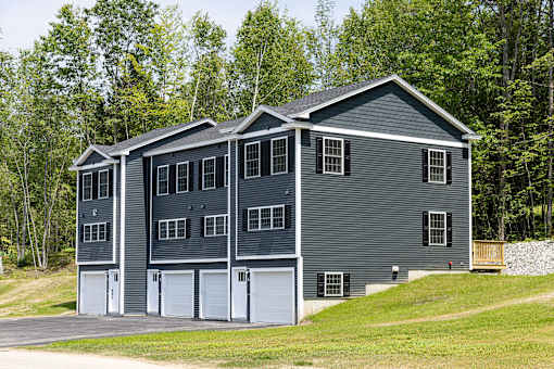 A grey house with a white garage door.