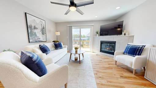 A living room with a fireplace and a painting on the wall.