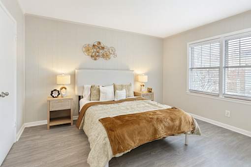A bedroom with a large bed and a chandelier.