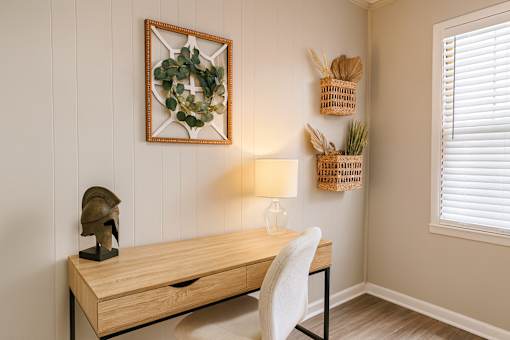 A desk with a lamp and a plant on it.