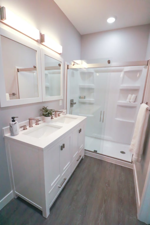a bathroom with a white sink and a shower