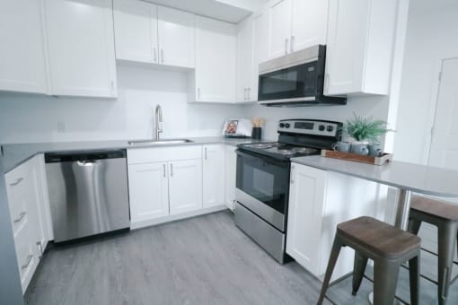 a kitchen with stainless steel appliances and white cabinets