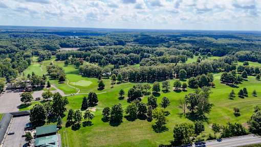 an aerial view of a park with green grass and trees