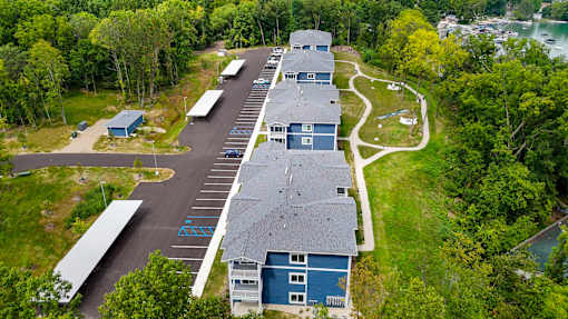 a view of a building from above with a parking lot