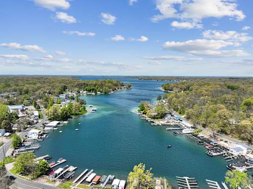 A serene view of a harbor with boats docked and a clear blue sky above.