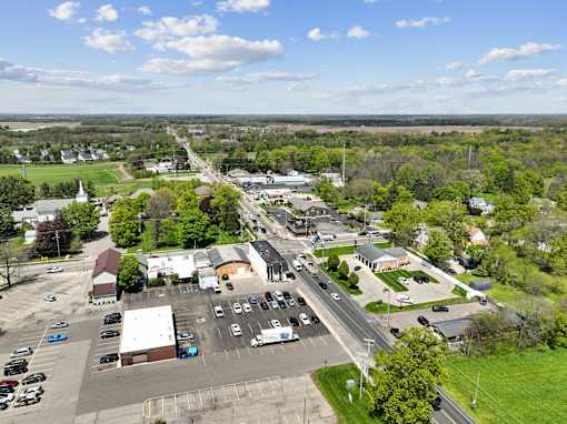 A small town with a large parking lot in the foreground.