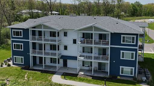 A large apartment building with a balcony on the second floor.