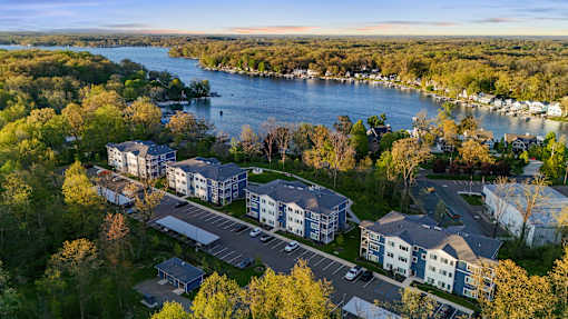 A bird's eye view of a residential area with a river in the background.