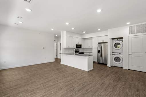 A spacious kitchen with a washer and dryer built in.