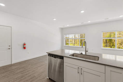 A kitchen with a stainless steel dishwasher and a sink.