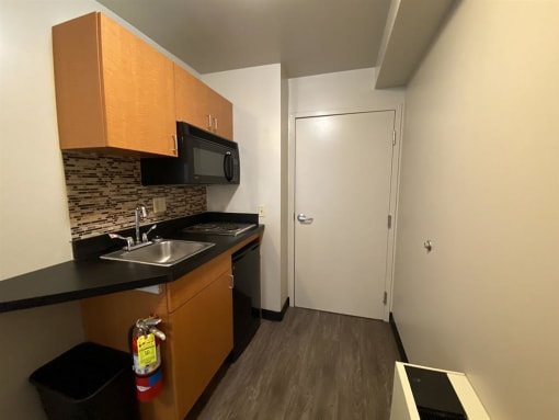 a small kitchen with a sink and a microwave