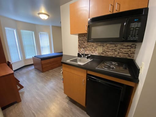 a small kitchen with a stove and a microwave