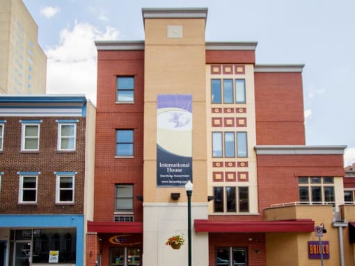 a large brick building with a clock on the side of it stock photography