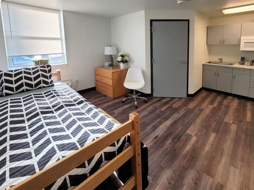 a bedroom with a bed and a sink and a door