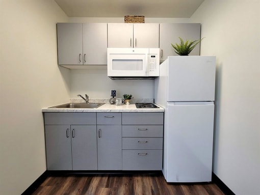a kitchen with a sink microwave and refrigerator