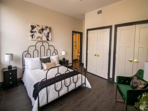 a bedroom with a bed and a green chair