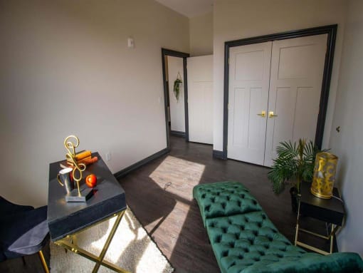 a hotel lobby with green chairs and a glass door