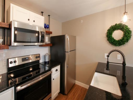 a kitchen with stainless steel appliances and black counter tops