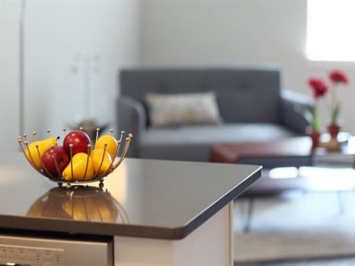 a bowl of fruit on a table in a living room