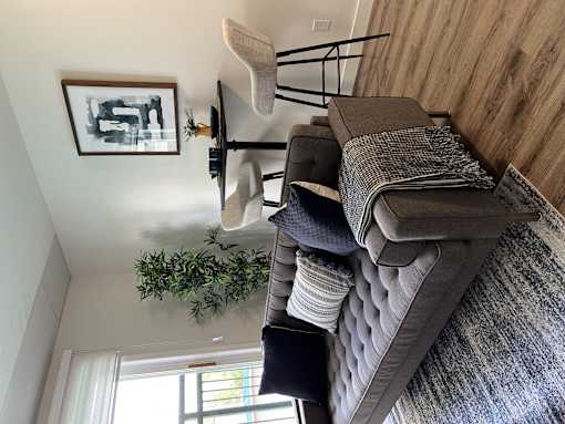 a living room with a couch and pillows on top of it